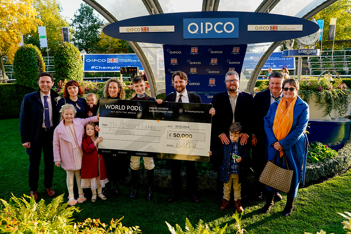 Billy Loughnane receives the £50,000 World Pool Jockeys’ Championship cheque alongside family and friends from The Christy Lambe Foundation’s representative, Michael Lambe